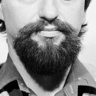 Man with beard and mustache in casual sweater.
