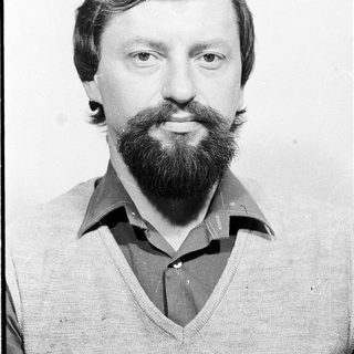 Man with beard and mustache in casual sweater.