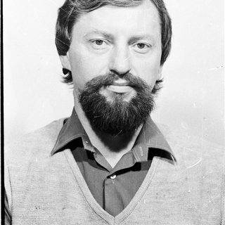 Man with beard and mustache in casual sweater.