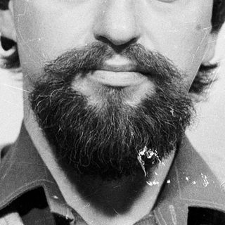 Man with beard and mustache in casual attire.