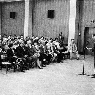 Formal lecture or meeting in auditorium setting.