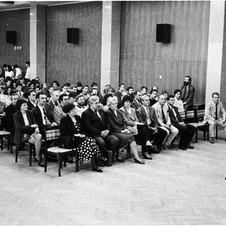 Formal lecture or meeting in auditorium setting.