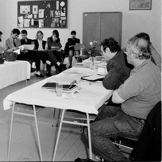 Classroom discussion or workshop with instructor and seated participants.