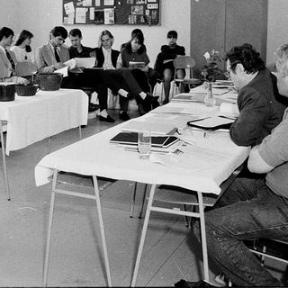 Classroom discussion or workshop with instructor and seated participants.