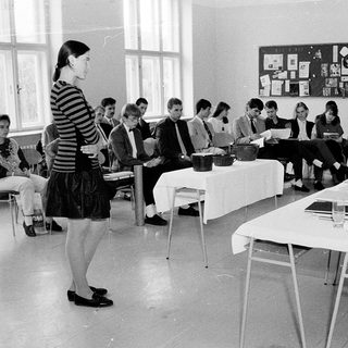 Classroom discussion or workshop with instructor and seated participants.