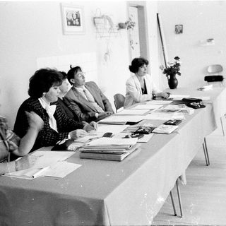 Meeting or conference with attendees seated and standing.