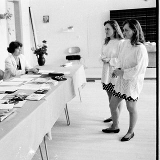 Meeting or conference with attendees seated and standing.