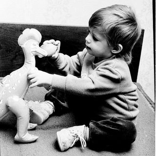 Young child playing with a duck toy.