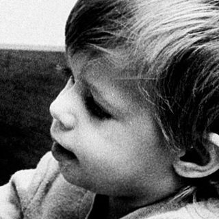 Young child playing with a duck toy.