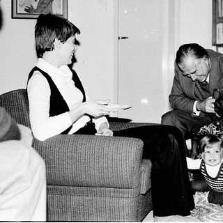 Family moment indoors with man, woman, and child.