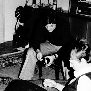 Two people playing board game indoors.