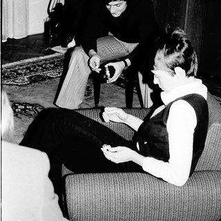 Two people playing board game indoors.