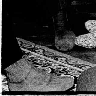 Three elderly women seated indoors during a social gathering.