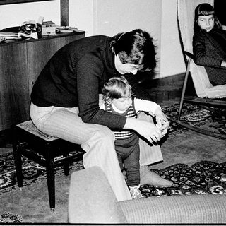 A woman comforting a young child indoors.