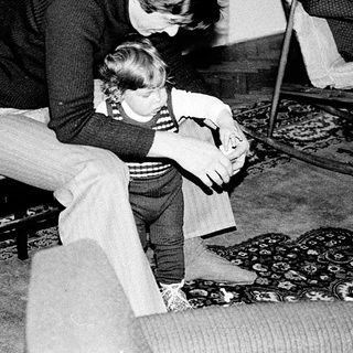 A woman comforting a young child indoors.