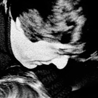 A woman comforting a young child indoors.
