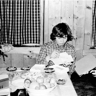 Child organizing or sorting items on table.