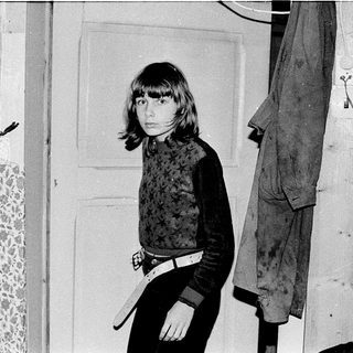 Young girl posing indoors with sword prop.
