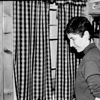 Person examining fabric or textile samples indoors.