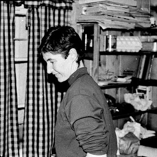 Person examining fabric or textile samples indoors.