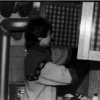 Person playing chess indoors near window.