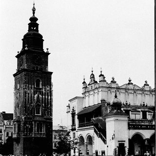 Historic city square with clock tower and cathedral.