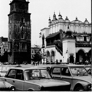 Historic city square with clock tower and cathedral.