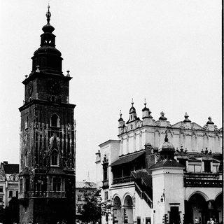 Historic city square with clock tower and cathedral.