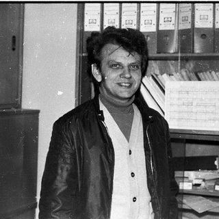 Man in office setting, mid-1970s to 1980s.