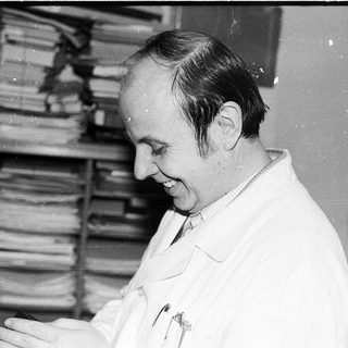 Scientist examining documents in laboratory setting.
