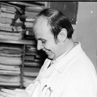 Scientist examining documents in laboratory setting.