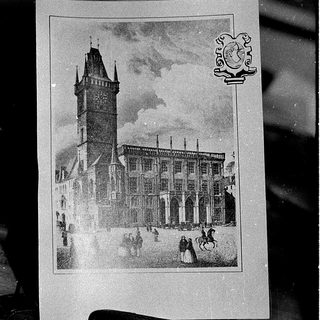 Historic building with clock tower and arched facade.