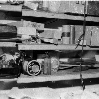 Vintage camera equipment on shelves.