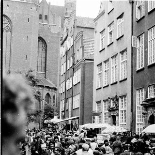 Crowded street market in historic European city.