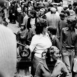 Crowded street market in historic European city.