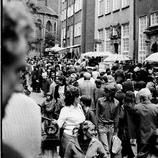 Crowded street market in historic European city.
