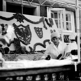 Historical butcher shop with workers preparing meat.