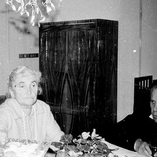 Older couple seated indoors during a meal.