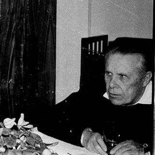 Older couple seated indoors during a meal.