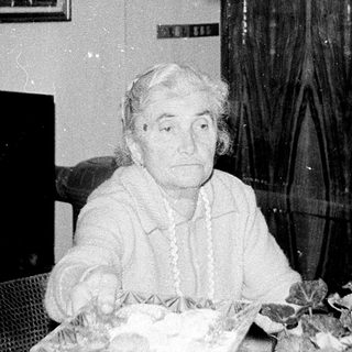 Older couple seated indoors during a meal.