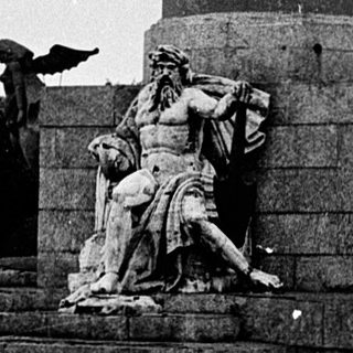 Tall column monument with naval and maritime sculptures.