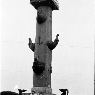 Tall column monument with maritime sculptures and observation deck.