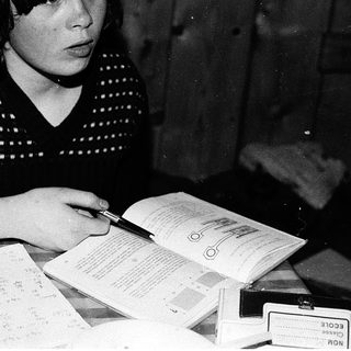 Woman filling out passport application at home.
