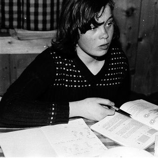 Woman filling out passport application at home.