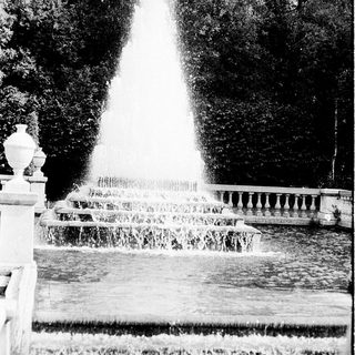 Elegant fountain in landscaped garden setting.