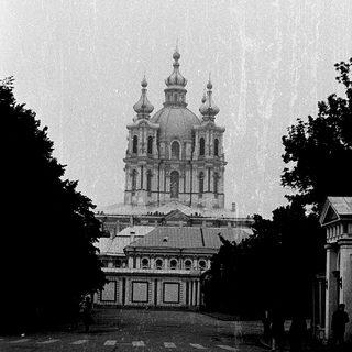 Elegant Orthodox church with domes on rainy day.