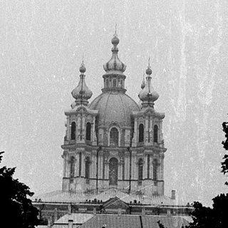 Elegant Orthodox church with domes on rainy day.