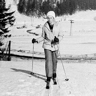 Person cross-country skiing on snow-covered trail.