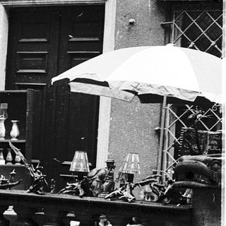 Vintage outdoor market with antique lamps and household items.