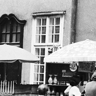 Vintage outdoor market with antique lamps and household items.